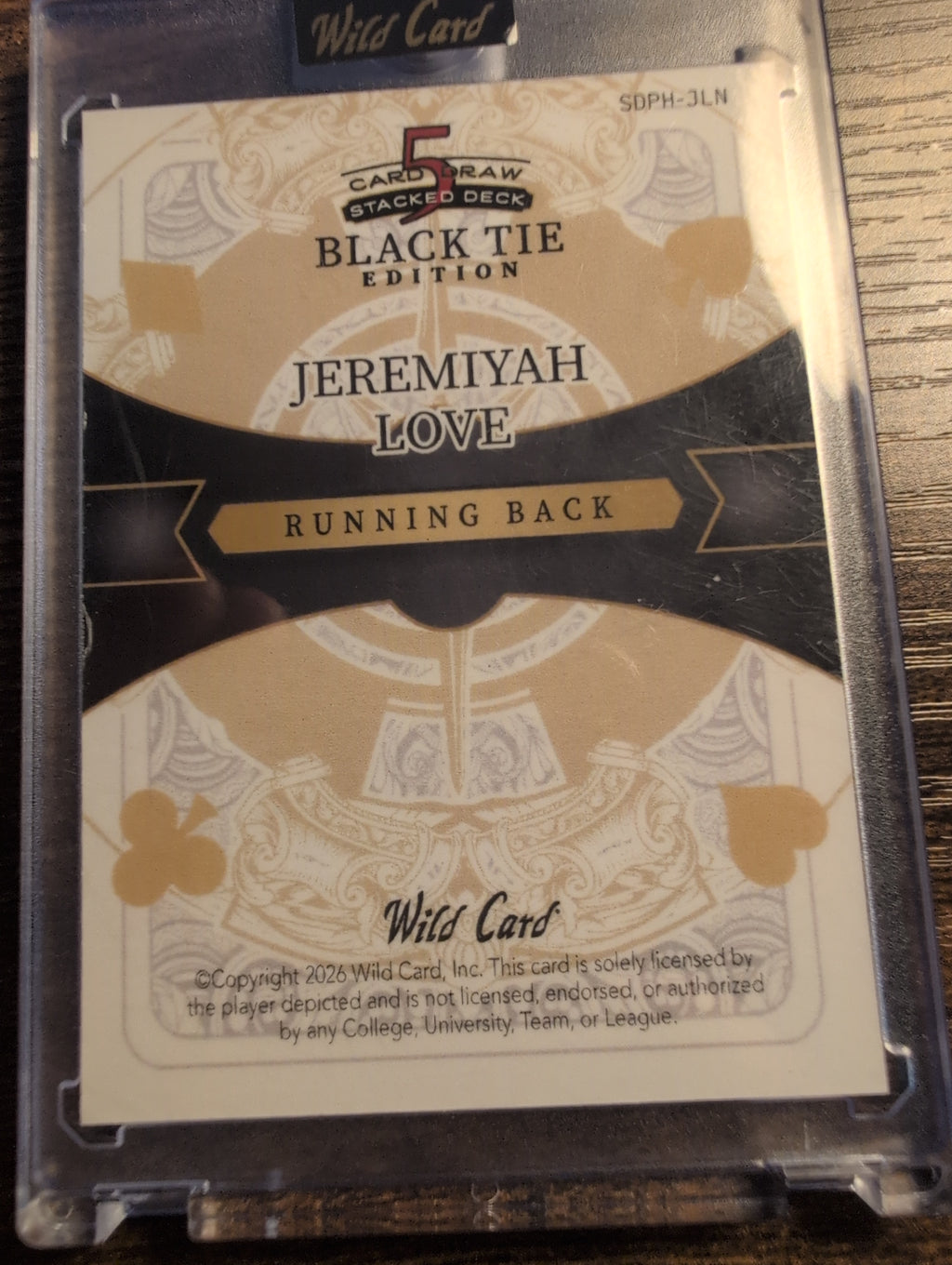 Back of 2026 Wild Card Jeremiyah Love Black Tie Edition with licensing statement