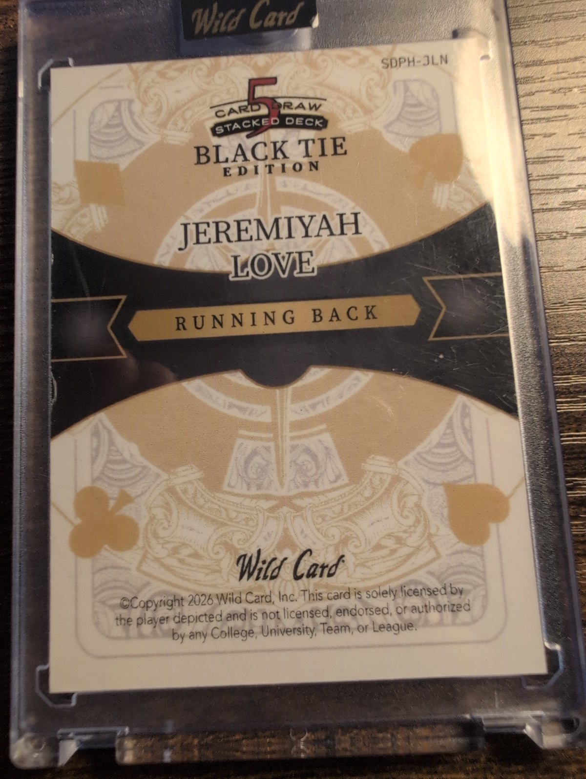 Back of 2026 Wild Card Jeremiyah Love Black Tie Edition with licensing statement